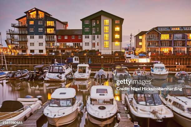 a dusk view of the marina (harbour) and adjacent apartments at exmouth, east devon, england, united kingdom, europe - devon stock pictures, royalty-free photos & images