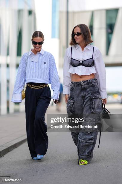 Guest wears black sunglasses, gold earrings, white and blue striped long sleeve Chanel shirt, navy blue pants, gold chain belt, golf chain heart,...