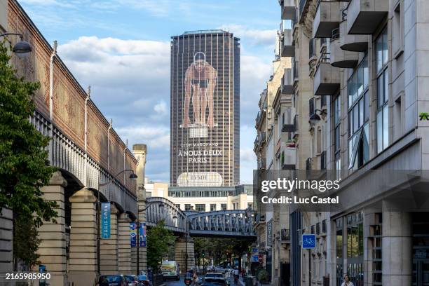 Giant image of France swimmer Leon Marchand is displayed on the Paris skyscraper Tour Montparnasse with the words A nous deux, Paris on August 07,...