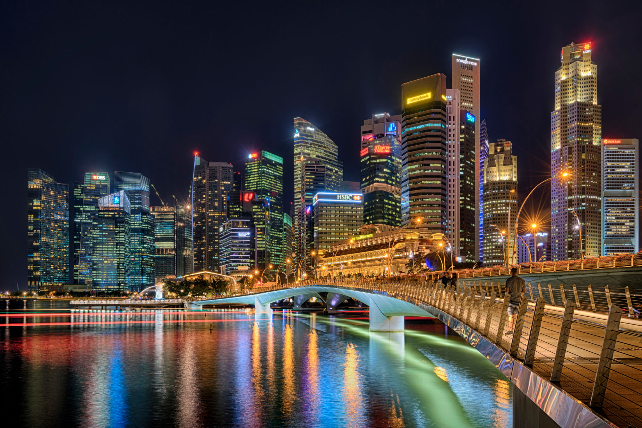 Illuminated Buildings By River Against Sky At Night Illuminated Buildings By River Against Sky At Night