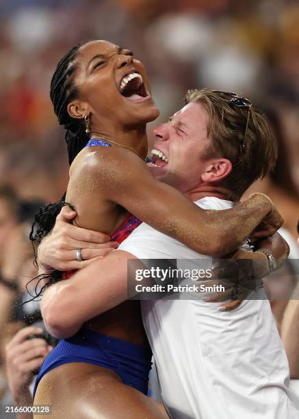 Tara Davis-Woodhall of Team United States celebrates winning the gold medal with husband Hunter Woodhall after competing in the Women's Long Jump...