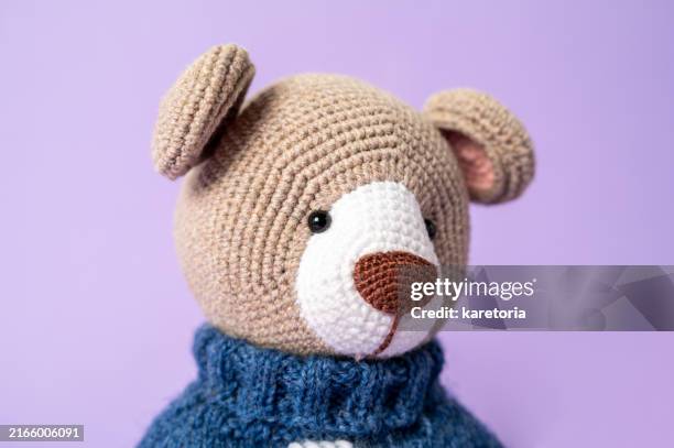 portrait of vintage-style crocheted teddy bear toy - purple teddy bear foto e immagini stock