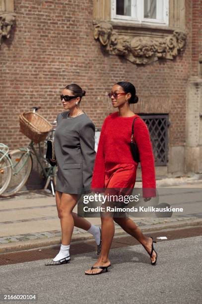 Benthe Liem wears grey long sleeve dress, white socks, grey pointy shoes and sunglasses and Amaka Hamelijnck wears red mini skirt, red long sleeve...
