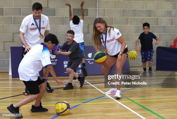 Olympic athletes, Freddie Davidson and Lola Anderson play with children at the North Paddington Youth Club during the launch of the National Lottery...
