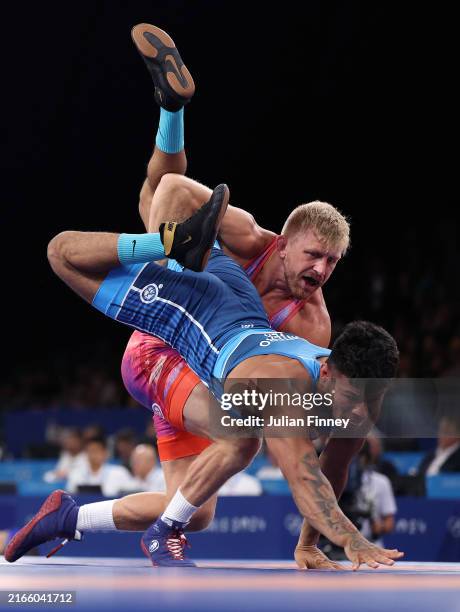 Kyle Douglas Dake of Team United States and Anthony Jose Montero Chirinos compete during the Men’s FreeStyle 74kg 1/8 Final match between Kyle...