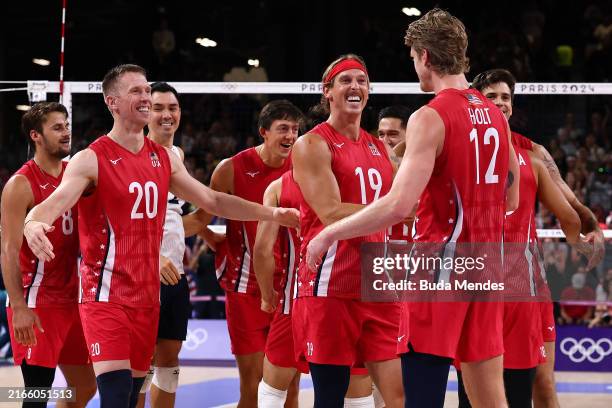 David Smith, Taylor Averill and Maxwell Holt of Team United States celebrate winning a Men's Bronze Medal Match between Team Italy and Team United...