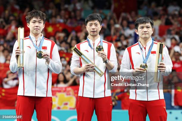 Gold Medalists Zhendong Fan, Long Ma and Chuqin Wang of Team People’s Republic of China pose on the podium during the Table Tennis Men's Team medal...