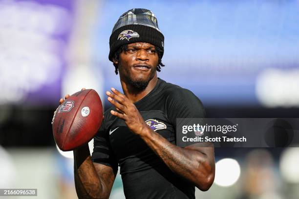 Lamar Jackson of the Baltimore Ravens warms up before a preseason game against the Philadelphia Eagles at M&T Bank Stadium on August 9, 2024 in...