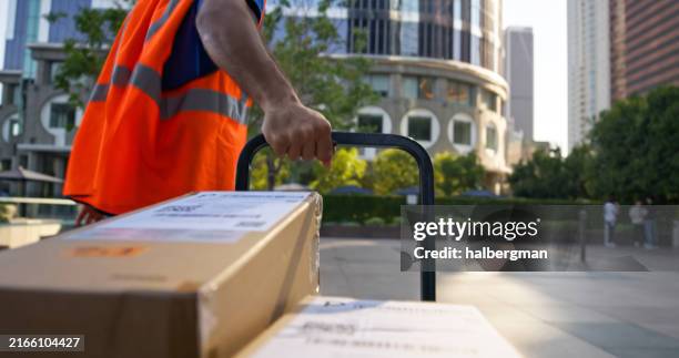 hand cart pov of delivery person pulling stack of boxes - mile stock pictures, royalty-free photos & images