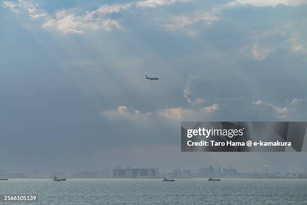 the airplane flying over the sea in kawasaki city of japan - tokyo bay stock pictures, royalty-free photos & images