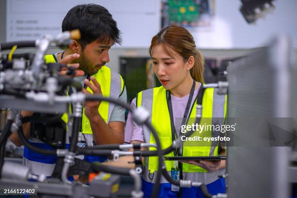 mechanics are working at ev car workshop. - new skill stock pictures, royalty-free photos & images