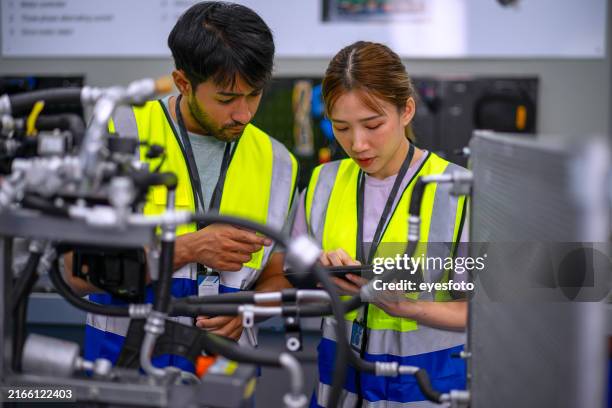mechanics are working at ev car workshop. - compressor stock pictures, royalty-free photos & images