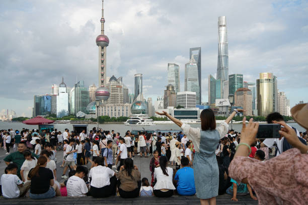 Capturing the Neon Pulse of Shanghai's Bund Waterfront 7 Tourists on Nanjing Road near Bund