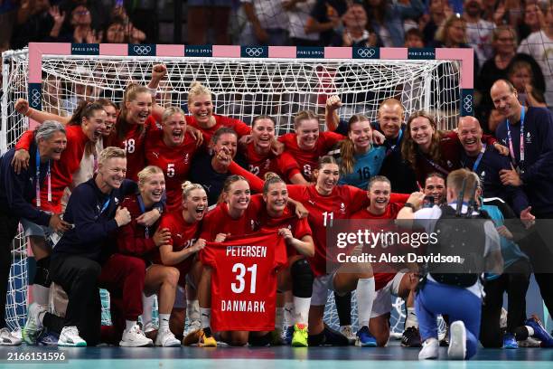 Bronze medalists Team Denmark pose for photo with a shirt of teammate Simone Petersen after she suffered a foot injury and withdrew from the Olympics...