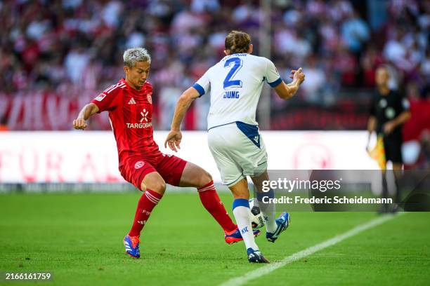 Shinta Appelkamp of Duesseldorf challenges Sebastian Jung of Karlsruhe during the Second Bundesliga match between Fortuna Düsseldorf and Karlsruher...