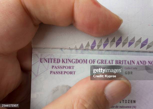 person holding uk passport - uk border control stock pictures, royalty-free photos & images