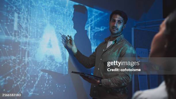 artificial intelligence developer team meeting at night - virtual speaker stock pictures, royalty-free photos & images