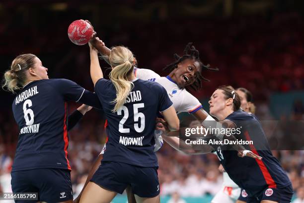 Meline Nocandy of Team France attempts to shoot the ball against Maren Aardahl, Henny Reistad, and Kari Brattset Dale of Team Norway during the...