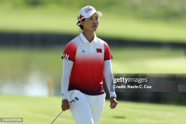 Janet Xiyu Lin of Team People's Republic of China looks across the 18th green during Day Four of the Women's Individual Stroke Play on day fifteen of...