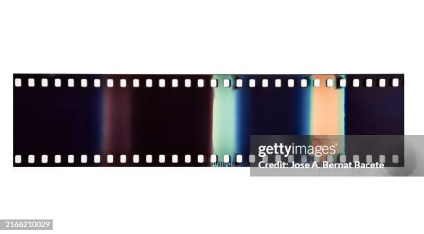 cut pieces of 35mm colour negative film on a white background. - old movie roll stock pictures, royalty-free photos & images