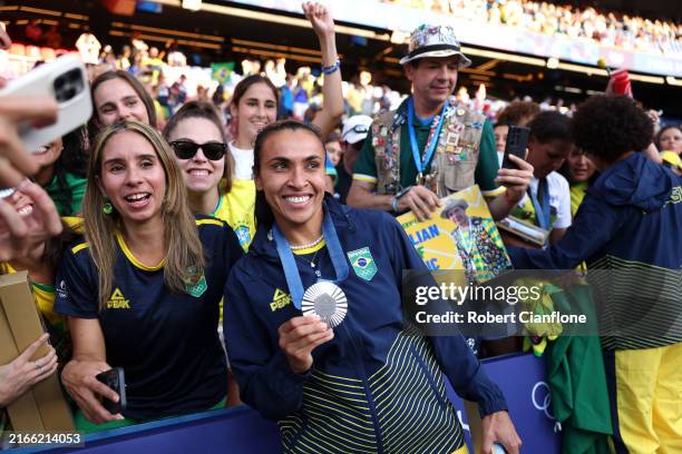 Silver medalist Marta of Team Brazil celebrates with fans after the Women's Football medal ceremony following the Women's Gold Medal match between...