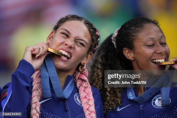 Trinity Rodman and Casey Krueger of the United States bite into their gold medals during the Gold Medal Ceremony after the Women's Gold Medal match...