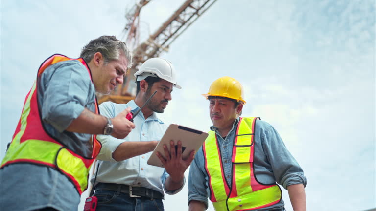 https://media.gettyimages.com/id/2166214586/video/group-of-workers-at-construction-site-are-discussing-construction-progress-with-a-tower-crane.jpg?b=1&s=640x640&k=20&c=mjgA8KKdCulcWQmT69FeY39YxCPAILKA9WlXDVkgMEU=