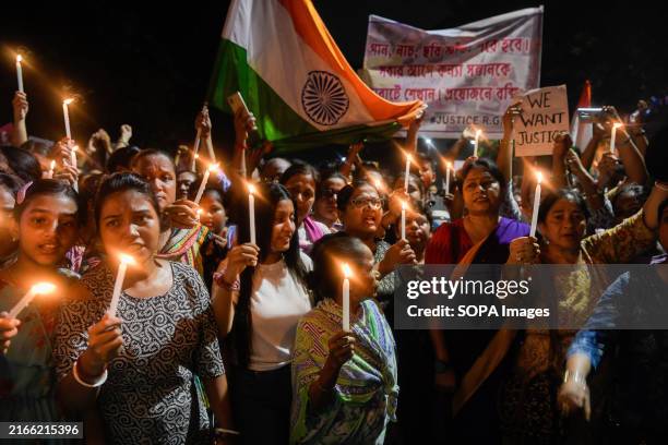 Women hold lit candles as they take part in a vigil named "Reclaim the Night". Thousands of people in different parts of Kolkata took part in a vigil...