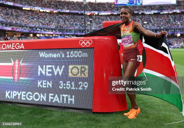Gold medalist and new Olympic record holder Faith Kipyegon of Team Kenya pose for a photo in front of the scoreboard following the Women's 1500m...