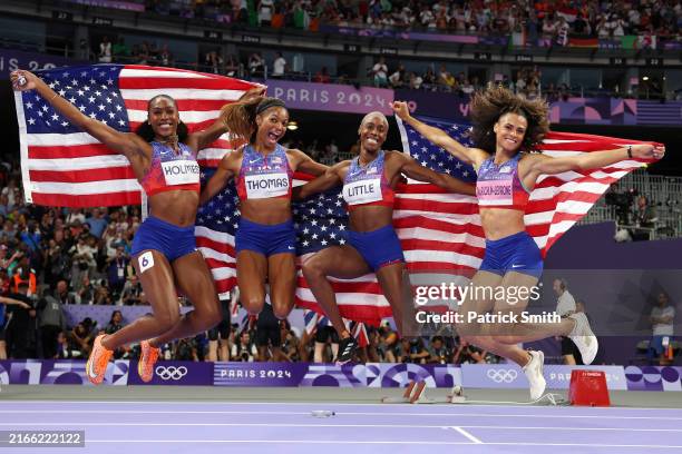 Shamier Little, Sydney McLaughlin-Levrone, Gabrielle Thomas and Alexis Holmes of Team United States celebrat winning the Gold medal in the Women's 4...