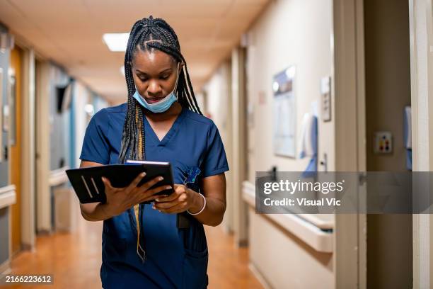 nurse reviewing notes from examination - medical school stock pictures, royalty-free photos & images
