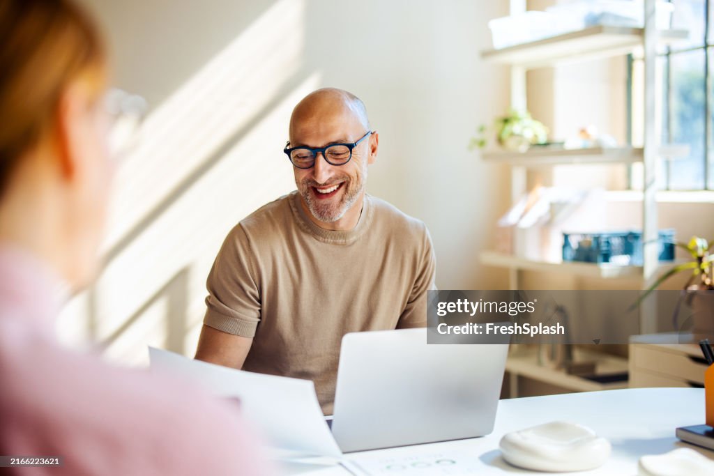 Smiling Man Having a Business Meeting in a Bright Office