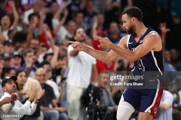 Stephen Curry of Team United States points to the crowd after a three point basket during the Men's Gold Medal game between Team France and Team...