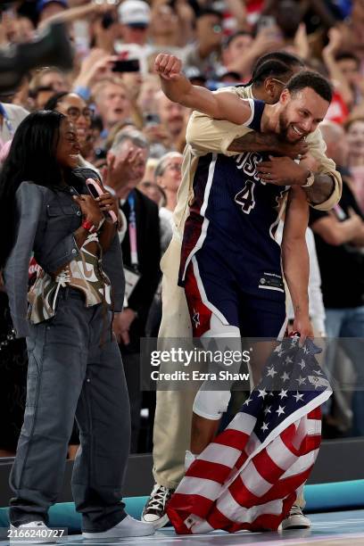 Former NBA player Carmelo Anthony hugs Stephen Curry of Team United States after Team United States' victory against Team France during the Men's...
