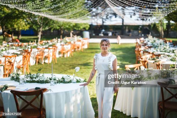portrait of the wedding planner, looking at the camera at the wedding venue. - managing committee stock pictures, royalty-free photos & images