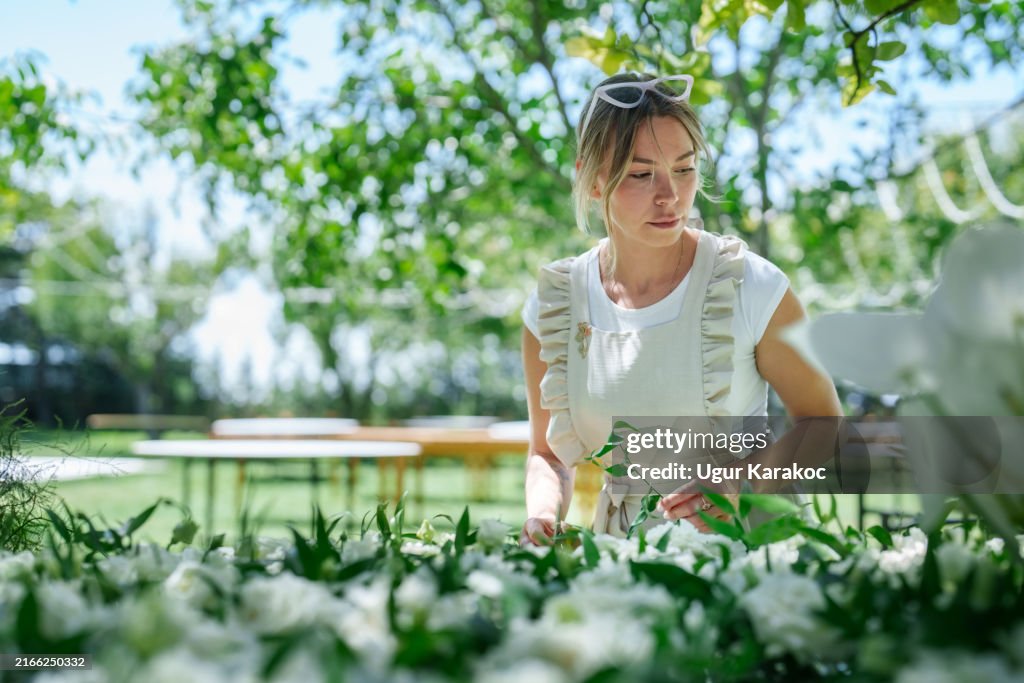 The wedding planning team is arranging the flowers.