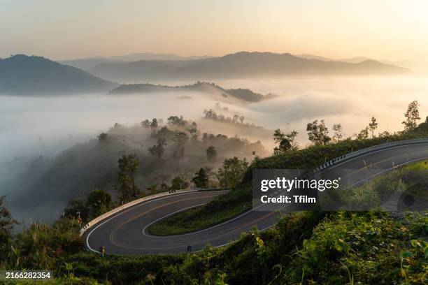 vehicle navigating sharp curve on foggy mountain road - best photo stock pictures, royalty-free photos & images