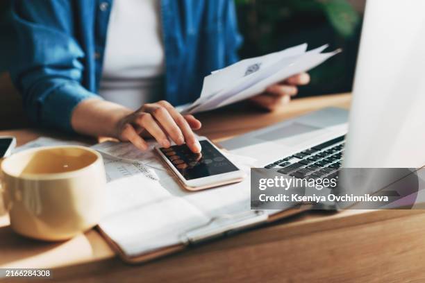 woman accountant use calculator and computer with holding pen on - rechenmaschine stock-fotos und bilder