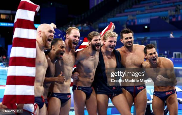 Members of Team United States pose for a photo following victory in the Bronze Medal match between Team United States and Team Hungary on day sixteen...