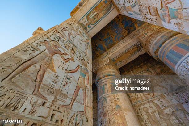 hieroglyphics detail at hypostyle columns at medinet habu temple luxor, egypt. - egypt stock pictures, royalty-free photos & images