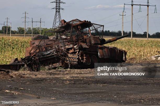 This photograph taken on 16 August during a media tour organised by Ukraine, shows a destroyed Russian tank outside Ukrainian-controlled Russian town...