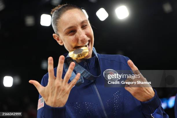 Gold medalist Diana Taurasi of Team United States holds up the number six, signifying her sixth Olympics gold medal, while posing for a photo during...