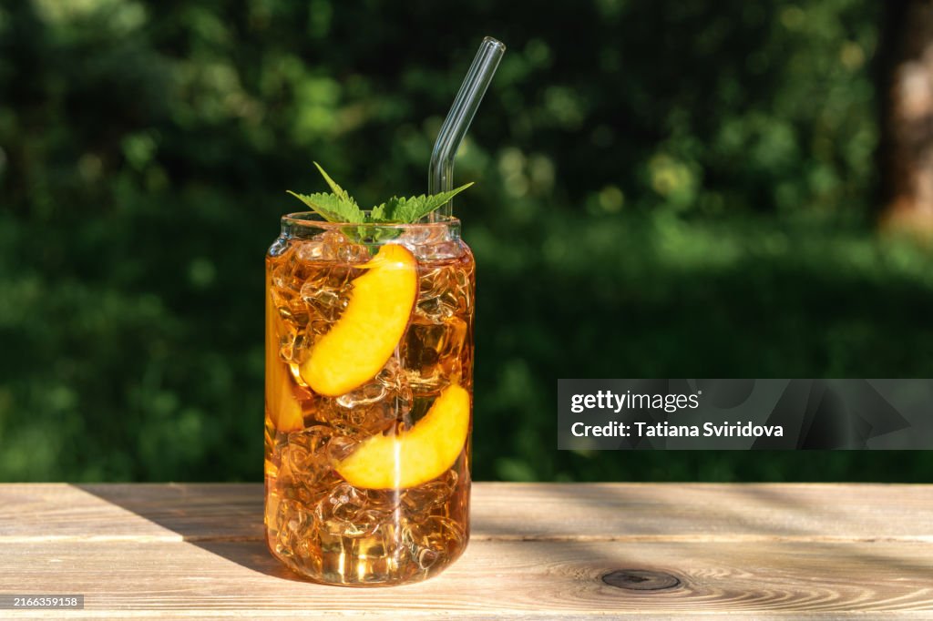 Glass of iced peach tea or mocktail drink