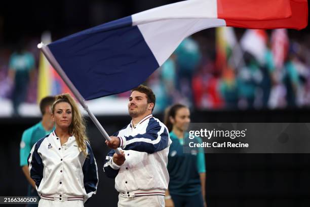 Flagbearers Antoine Dupont and Pauline Ferrand Prevot of Team France wave their national flag during the Closing Ceremony of the Olympic Games Paris...