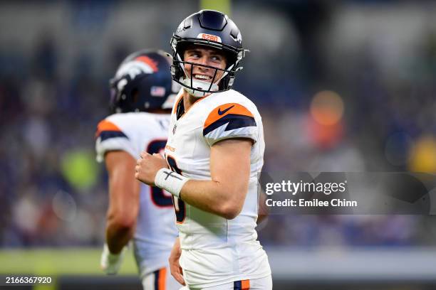 Bo Nix of the Denver Broncos smiles after a touchdown during the second half of a preseason game against the Indianapolis Colts at Lucas Oil Stadium...