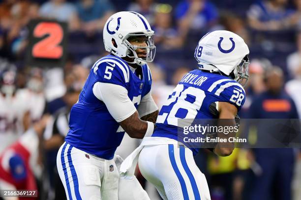 Anthony Richardson hands off the ball to Jonathan Taylor of the Indianapolis Colts during the first half of a preseason game against the Denver...