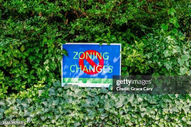 nimby anti-zoning sign surrounded by lush foliage - nimby stock pictures, royalty-free photos & images