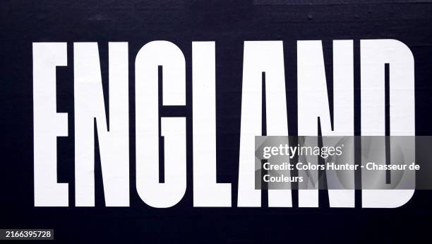 england in white block letters on a black background. close-up of printed a poster in london, england, united kingdom. sunlight. natural colors. - typografie stock-fotos und bilder
