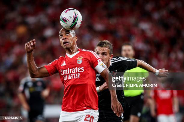 Benfica's Portuguese midfielder Joao Mario heads the ball next to Casa Pia's Bosnian defender Nermin Zolotic during the Portuguese league football...