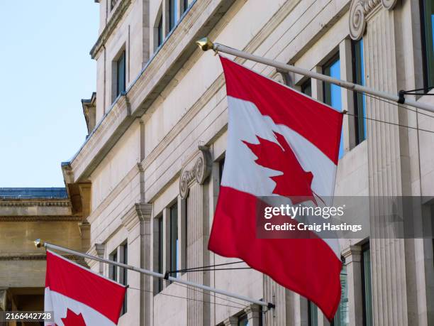 canadian flags flying outside the high commission of canada in the united kingdom london - canada stock pictures, royalty-free photos & images